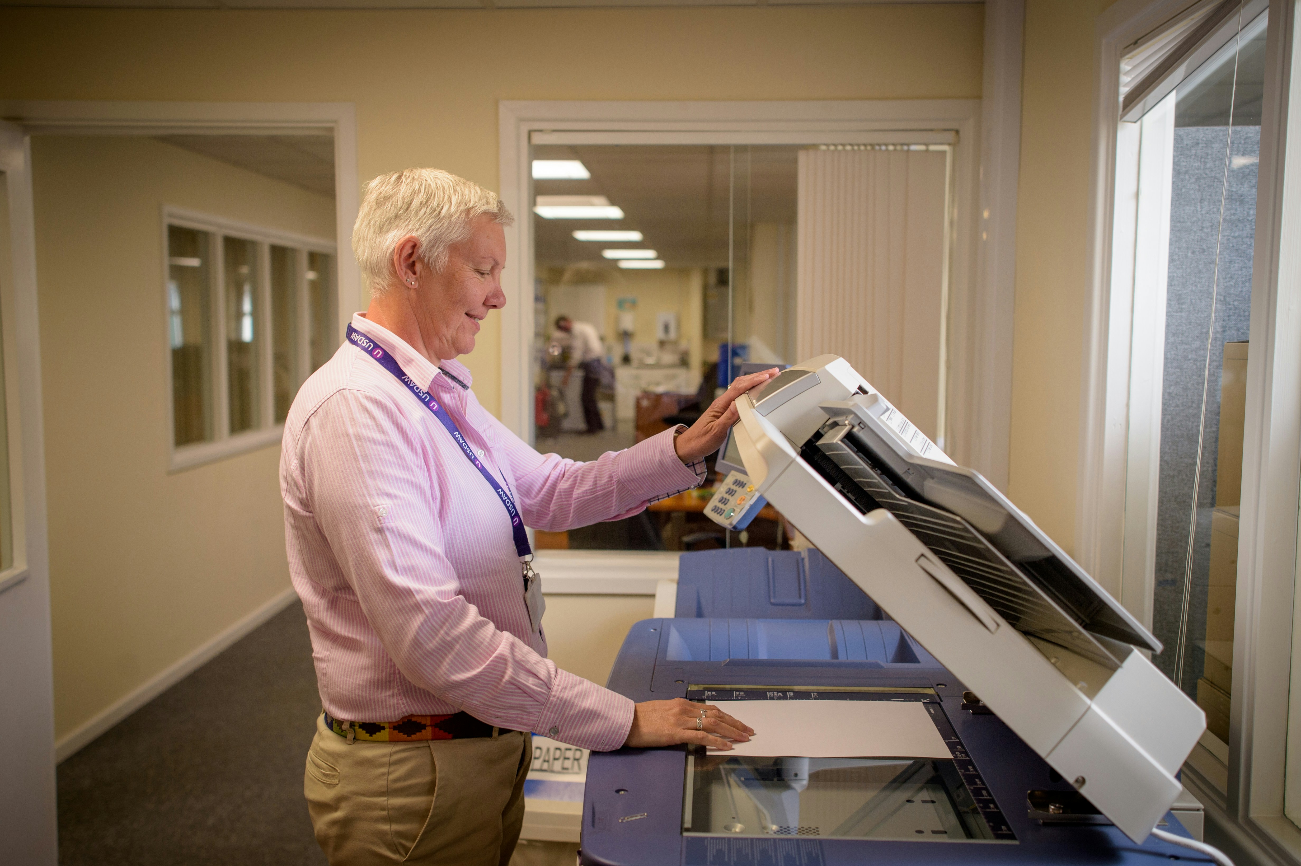 Person using a printer in an office